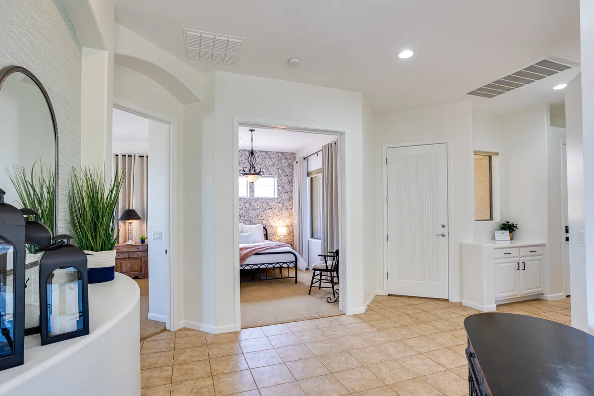 This image features the entrance hallway of the home, decorated with stylish lanterns and offering a glimpse of a tranquil bedroom beyond. The space feels calm and inviting, establishing the first impression guests receive upon arrival and hinting at the peaceful retreat within.